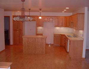 Custom built oak cabinets. 
Under cabinet lighting. 
Laminate wood flooring. 
Spacious kitchen/dining area.